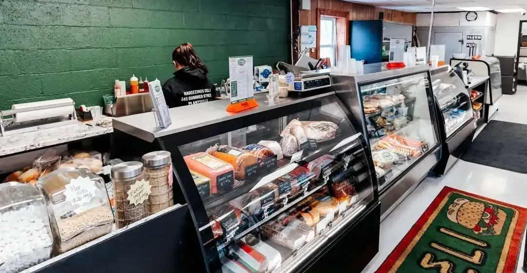 The deli counter at Ragozzino's: glass cases of meats, salads and desserts along the green wall